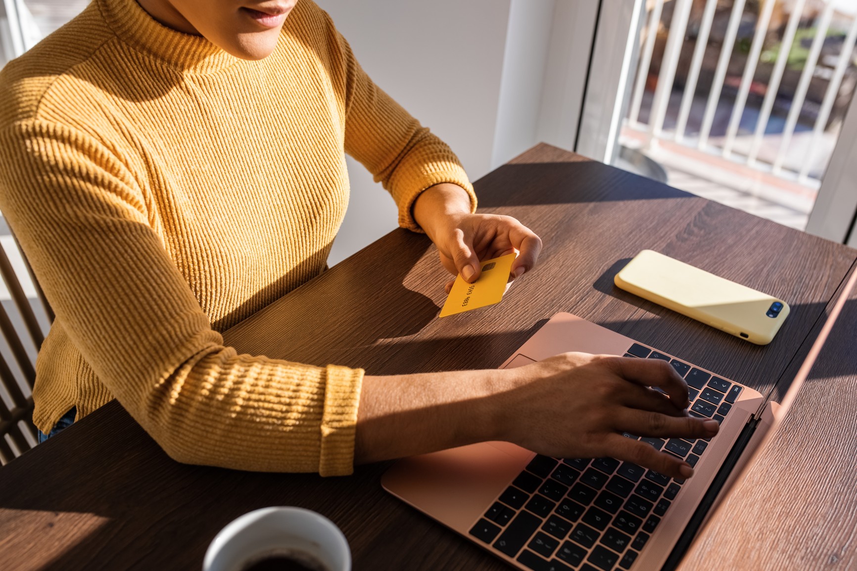 Person sitting by window working on tablet