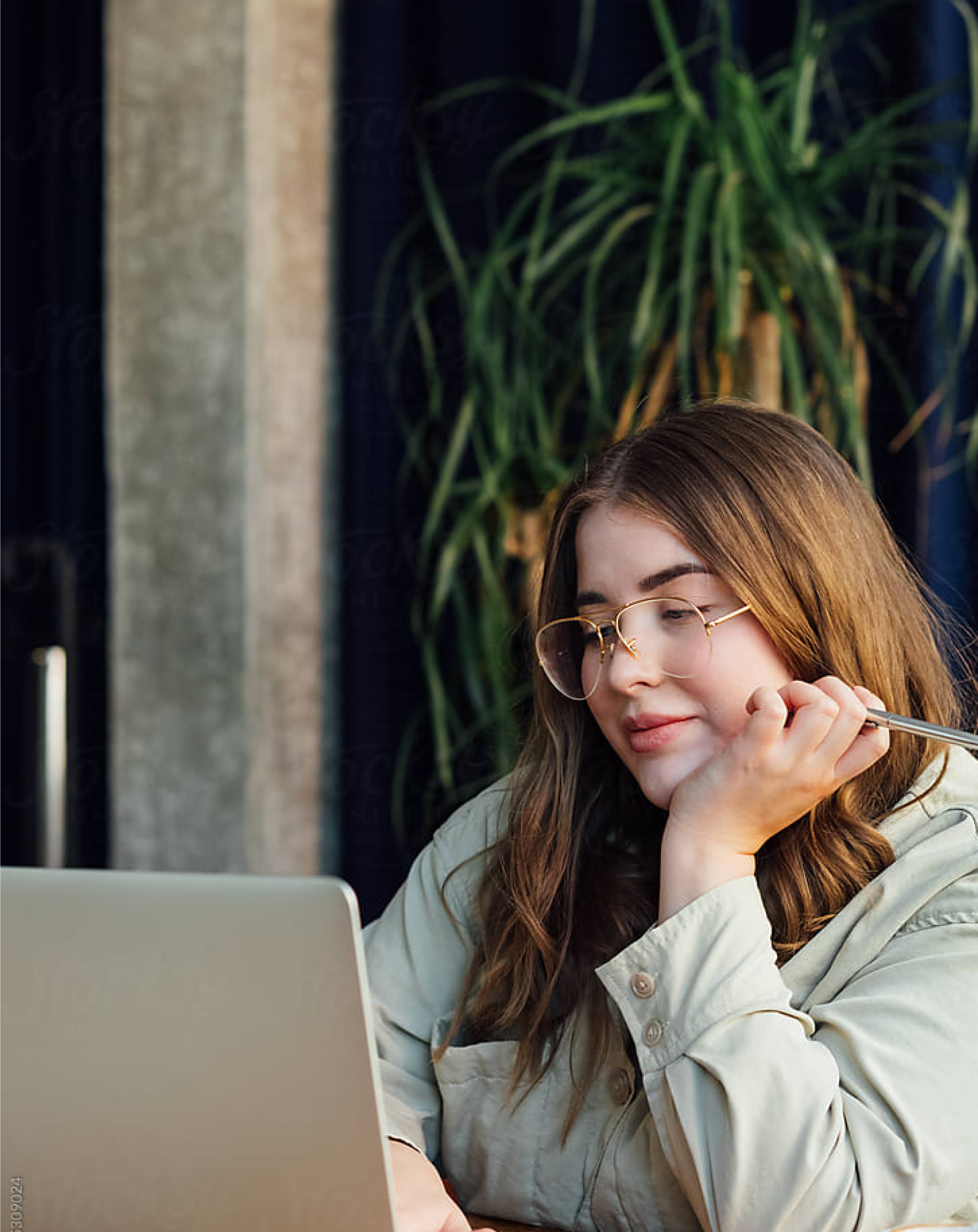 Person sitting by window working on tablet